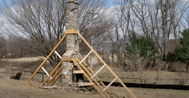 Transformation of a home built around an original 1800s log cabin fireplace